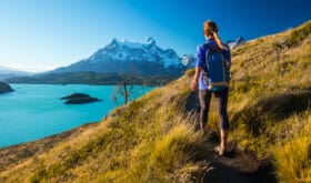 Woman hiker walks on the trail in the Torres del Paine National Park. Chile
