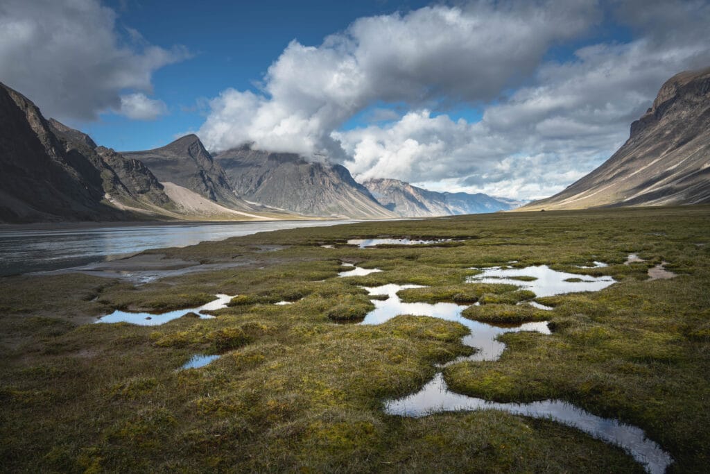 Beautiful landscape of Water front view of mountains on Akshayuk Pass, Buffin Island, Canada. Pond reflections